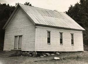 The church sanctuary on Indian Creek shown here was erected about 1900 and was used until 1947 when it was forced to move due to the building of the Center Hill Dam. Much of the lumber from this building was salvaged and used in the existing church building along with an oil-fueled chandelier which occupies a prominent place near the pulpit.