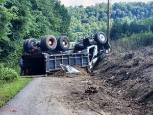 53 year old Johnny Jones was driving down a steep grade in his 1982 Ford dump truck for the Top Soil Company of Cookeville, when he went off the left side of the road and struck an embankment causing the truck to rollover onto its top in the roadway