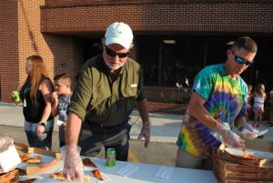 School Board Chairman W.J. (Dub) Evins III and Director of Schools Patrick Cripps preparing to serve up pizza at Education Celebration