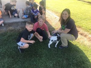 DeKalb Animal Shelter Director Megan Moore shows off puppy to DeKalb West 2nd graders