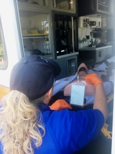 Donna Melton-AEMT of DeKalb EMS loads onto an ambulance and treats a critical (mannequin) patient Thursday at Green Brook Park during a simulated tornado touchdown disaster drill