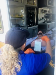 Donna Melton-AEMT of DeKalb EMS loads onto an ambulance and treats a critical (mannequin) patient Thursday at Green Brook Park during a simulated tornado touchdown disaster drill