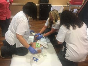 Nursing staff at NHC Healthcare Center of Smithville treat mannequin victim from a simulated tornado touchdown Thursday morning at Green Brook Park. NHC served a triage site for patient assessment.