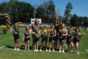 Junior Pro Football Junior Cheerleaders recognized during Homecoming Saturday: left to right- MeKazya Waggoner, Lyra Dell McMinn. Faith Knowles, Kynsley Hamilton, Alexis Graham, Nora Dykes, Zoie Dee Ashburn, Caitlyn Adcock. Coaches Amanda McMinn and Andria Graham