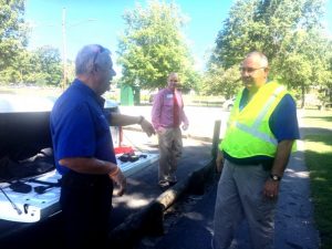 DeKalb EMA Director Charlie Parker talking to DeKalb EMS Director Hoyte Hale with Clint Hall, NHC Healthcare Center Director in the background