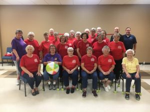 DeKalb County Seniors Chair Volleyball Team pictured with sponsors Clint Hall of NHC Smithville, Casey Midgett of First Bank (standing on back row to the right), and Jan Thomas (standing) and Debbie Repasy (seated) representing the Smithville Lions Club (wearing purple shirts). Thelma Williams, 94 year old team member, is seated far right and wearing yellow top