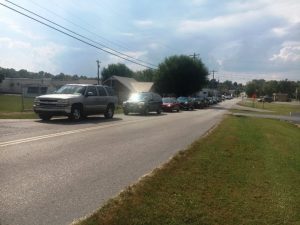 Parents line up in their automobiles from South Congress Boulevard to East Bryant Street before classes dismiss weekday afternoons