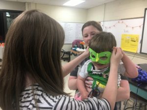 Superhero tyke tries on his mask during Superhero STEAM night at DCHS Monday