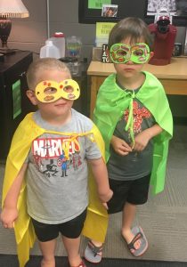 3 year old Jayden and 6 year old first grader Wyatt Cain show off their superhero costumes made during Superhero STEAM night at DCHS Monday