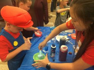 Students making superhero slime during Superhero STEAM night at DCHS Monday