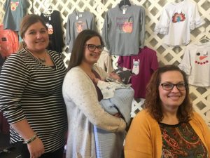 Courtney O’Conner, Amber Judkins holding baby Case O’Conner, and Melanie Judkins at Paislee’s Foundation Craft & Home Show Saturday