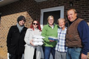 Jo Marie Rackley (second from right) was among hundreds served a hot and delicious Thanksgiving Day Meal courtesy of the DeKalb Emergency Services Association in partnership with local businesses and volunteers. Making the delivery to Ms Rackley and pictured left to right: Jim Sherwood, Osiris Mancera, Beth Gill, and Darrell Gill