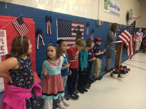 Boy and Girl Scouts present the flag