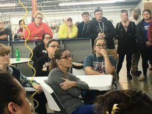 Employees of 620 Pelham, Inc.(formerly known as Omega Apparel) take a break from work Thursday for a meeting to hear from plant manager Amanda Callis and consultant Dick Chase on plans for the new industry.