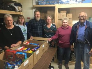 Gods Food Pantry volunteers Rose Dillen, Bernice Hendrixson, Stevie and Brenda Cripps, Pat Zornow, and James Owens.