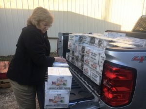 Smithville Food Lion employee Delois Bratcher helps unload truck filled with “Food Lion Holidays without Hunger” food boxes at God’s Food Pantry in Smithville Wednesday.