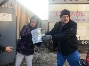 Smithville Food Lion Manager Greg Eller and employee Vicki Heisler help unload truck filled with “Food Lion Holidays without Hunger” food boxes at God’s Food Pantry in Smithville Wednesday.