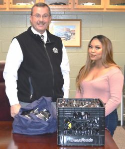 Sheriff Patrick Ray presents 290 donated cell phones to Keesha Williams of the Genesis House for use by victims of domestic and sexual violence