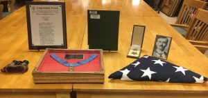 Charles P. Cantrell of DeKalb County received the Medal of Honor, the U.S. military’s highest award for valor for his heroic actions during the Spanish-American War. Cantrell’s medal and other belongings which have been on display at Justin Potter Library since 1995, will be on loan to the Charles H. Coolidge National Medal of Honor Heritage Center of Chattanooga through May 13 for an exhibit titled “Honoring the Sacrifice: Medals of Honor Through Time”. Shown here: Cantrell’s medals, photo, binoculars, citation, and American flag