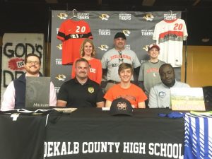 Bill Miller, a star Tiger Soccer player signed a letter of intent with Milligan College near Johnson City, Tennessee in March to play collegiate soccer for the Buffaloes. Joining Miller for the signing were members of his family, coaches, and fellow players. Pictured seated left to right are DMS Soccer Coach Justin Nokes, DCHS Soccer Coach Dylan Kleparek, Bill Miller, and Miller’s Club Soccer Coach Tre Arhatba. Standing left to right are Miller’s family including mother Kate, father Billy, and brother Cameron Miller