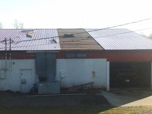 High winds from a powerful storm early Sunday morning caused some structure damage and power outages for several hours in DeKalb County. Picture here shows a portion of metal roof blown off the rear of Mystick Market on Highway 56 South which came to rest against a home across the highway.