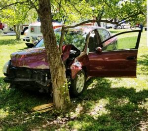 28 year old Shawn Edwards of Smithville was traveling north Friday morning in a 2011 Maroon Nissan Altima when he lost control and ran off the left side of the roadway into the yard of 7978 Holmes Creek Road hitting both a 2008 blue Toyota and a 1972 yellow Ford F100 pickup truck and then a tree. (Photo by Jim Beshearse)