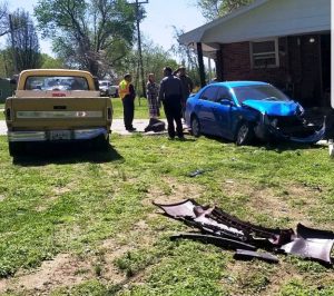 28 year old Shawn Edwards of Smithville was traveling north in a 2011 Maroon Nissan Altima Friday morning when he lost control and ran off the left side of the roadway into the yard of 7978 Holmes Creek Road a 2008 blue Toyota and a 1972 yellow Ford F100 pickup truck (shown here) belonging to Troy and Jeanna Bain which were parked in the driveway of the residence. The impact of the crash forced the Toyota into a support beam of the home’s carport. Edwards’ car then struck a tree. Edwards said be blacked out while driving causing him to lose control and run off the roadway. No one was injured. (Jim Beshearse photo)