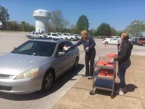 Supervisor of Instruction Dr. Kathy Bryant and DCHS Assistant Principal Jenny Norris handing out food during Thursday’s drive through distribution at DCHS.