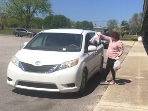 DeKalb Middle School staff handed out bags of food Thursday in drive through pickup line