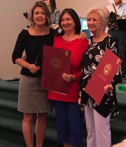 Two longtime DeKalb County educators, Walteen Carter Parker (right) and Susan Frazier Hinton (center), have been recognized by state lawmakers on the occasion of their retirement. State Representative Terri Lynn Weaver (left) presents copies of the joint House and Senate resolutions honoring them which were signed by the Governor