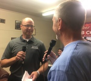 Chad Colwell (left) of Wilson Bank & Trust presents $1,000 donation during WJLE Project Graduation Radiothon