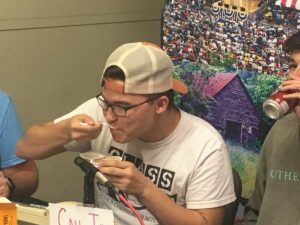 DCHS student Raiden Martin forced down a spoonful of dog food to meet a pledge challenge during the WJLE Radiothon last year