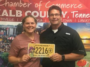 Jessica Dodds Davis (pictured here with County Clerk James L. (Jimmy) Poss) is all abuzz about a new specialty license plate which she created dedicated to saving the honey bee. The state recently unveiled the new “Save the Honey Bee” plate which is now available for sale at county clerk’s offices across the state. A portion of the fee from sales of the plates will be allocated to Honeybee Tennessee, a non-profit organization founded by Davis, to be used exclusively to support the mission of educating the community on the importance of honeybees, including providing funding for local schools and camps for the appropriate equipment and educational materials needed for beekeeping.