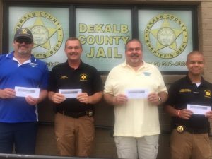 As a way of showing support and appreciation to the department, John Flanders (far left), President of Botanical Incorporated of McMinnville, and Tony Bess (second from right), owner of Smithville Marine, presented Sheriff Patrick Ray and Chief Deputy Robert Patrick (far right) certificates for each sheriff’s department employee at Fireman One Barbeque in Smithville.