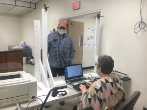 Plexiglass sneeze guards between election workers and voters are part of the safety precautions in place for August 6 Elections and Early Voting. Election workers Ronnie Redmon and Darlene Willingham shown here are also wearing masks
