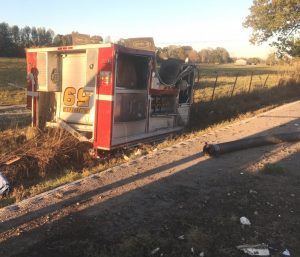 The rear portion of the fire truck separated from the cab and chassis and landed upside down and across the road from where the cab came to rest