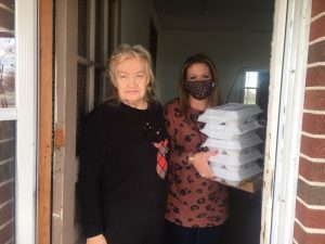 Circuit Court Clerk Susan Martin (right) delivers Thanksgiving Day meals to Carmine Bain on behalf of the DeKalb Emergency Services Association