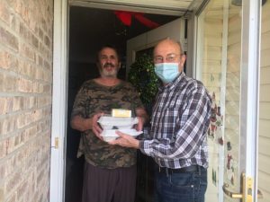 County Mayor Tim Stribling (right) delivers Thanksgiving Day meals to Jackie Fults on behalf of the DeKalb Emergency Services Association