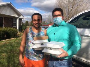 County Clerk James L. (Jimmy) Poss (right) delivers Thanksgiving Day meals to Jordan Pinegar on behalf of the DeKalb Emergency Services Association