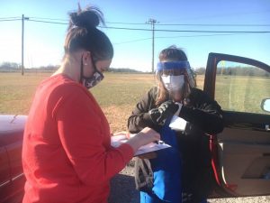 DeKalb Health Department Health Educator Megan Kinslow and LPN Ronda Johnson preparing to administer a dose of Moderna COVID-19 vaccine