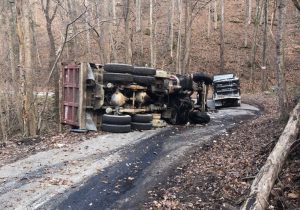 Dump Truck Driver Escapes Injury in Rollover Crash