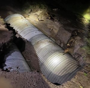 Flood waters wash out one place of Possum Hollow Road down to the tile preventing travel