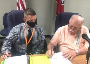 Director of Schools Patrick Cripps gets Bonus and Contract Extension from Board of Education. Director Cripps (left) with Board Chairman Danny Parkerson (right) signing the new contract