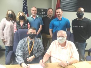 Director of Schools Patrick Cripps (seated left) and Board of Education Chairman (seated right) with fellow School Board members (standing left to right) Jamie Cripps, Kate Miller, Alan Hayes, Jim Beshearse, Jason Miller, and Shaun Tubbs