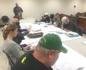 Members of the DeKalb County Budget Committee with DeKalb Fire Chief Donny Green (standing) Pictured left to right: Jeff Barnes (wearing green cap), Sabrina Farler, Dr. Scott Little, Beth Pafford, Julie Young (wearing white cap), Jenny Trapp, and Jerry Adcock.(older photo)