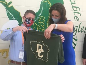 Director of Schools Patrick Cripps presents Tennessee Education Commissioner Penny Schwinn a DeKalb County Schools tee shirt during her visit Friday to Northside Elementary School which she wore during her tour of the school