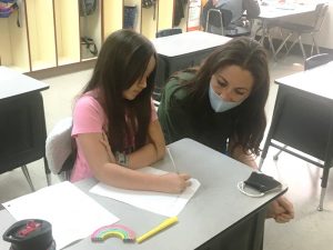 Tennessee Commissioner of Education Penny Schwinn observes Northside Elementary School student Ellie Adkins doing her classroom work during a visit to the school in April