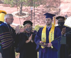 Nick Parsley, brother of the late Zachary Tyler Parsley accepts Zach's degree during Tennessee Tech Commencement Friday