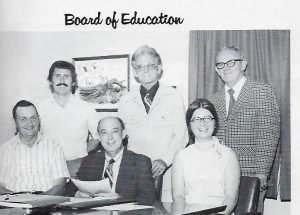 Photo from DCHS 1977 Yearbook shows Sue Puckett as member of the Board of Education. Pictured seated left to right are Austin Barnes (6th district member), Superintendant of School E.G. (Elzie) Mcbride and Sue Puckett (3rd district member). Standing left to right: Dr. Larry Puckett (4th district member), Martin S. (Easy) Scott (1st district member), and C.T. (Clarence) Phillips, Jr. (7th district member). Not pictured were James (Doober) Miller (2nd district member) and Toy Fuson (5th district member)