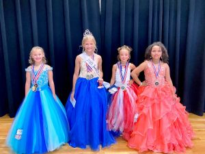 Miss Jamboree Pageant 7-10 age division: 10 year old Ella Kirksey (2nd from left) is the Queen in the 7-10 year old age group. She is the daughter of Graden and Sabrina Kirksey of Smithville. Ella was also awarded for Most Photogenic and Prettiest Eyes. Haylee Brooklyn Thompson (2nd from right) was named 1st runner-up. She is the 8 year old daughter of John and Cora Thompson of Hampshire, Tennessee. 2nd runner-up went to 9 year old Kendall Huskey (far left), daughter of Tiffany Rad and Marc Huskey of Manchester. She also earned honors for People’s Choice and Prettiest Attire. 8 year old Arraya Jenae Taylor (far right) of Smithville was 3rd runner-up. She is the daughter of Angie Taylor.